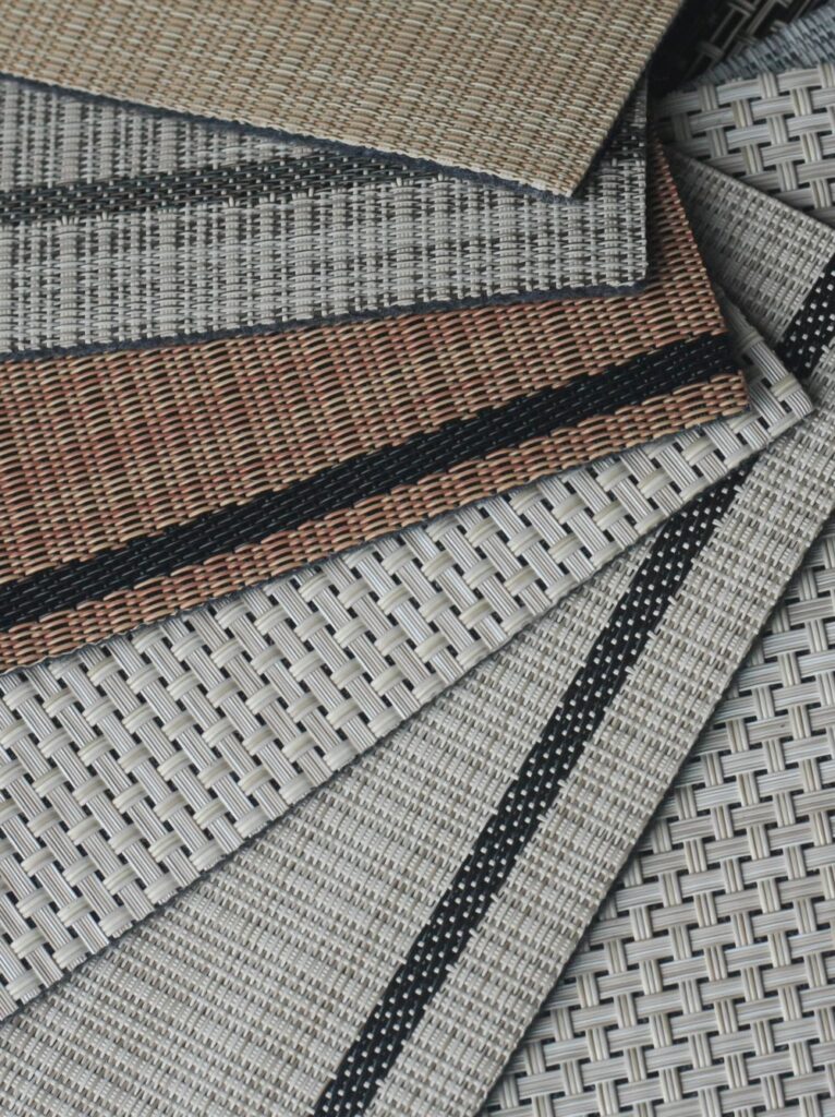 Different woven vinyl flatweaves styles laid flat and fanned out.